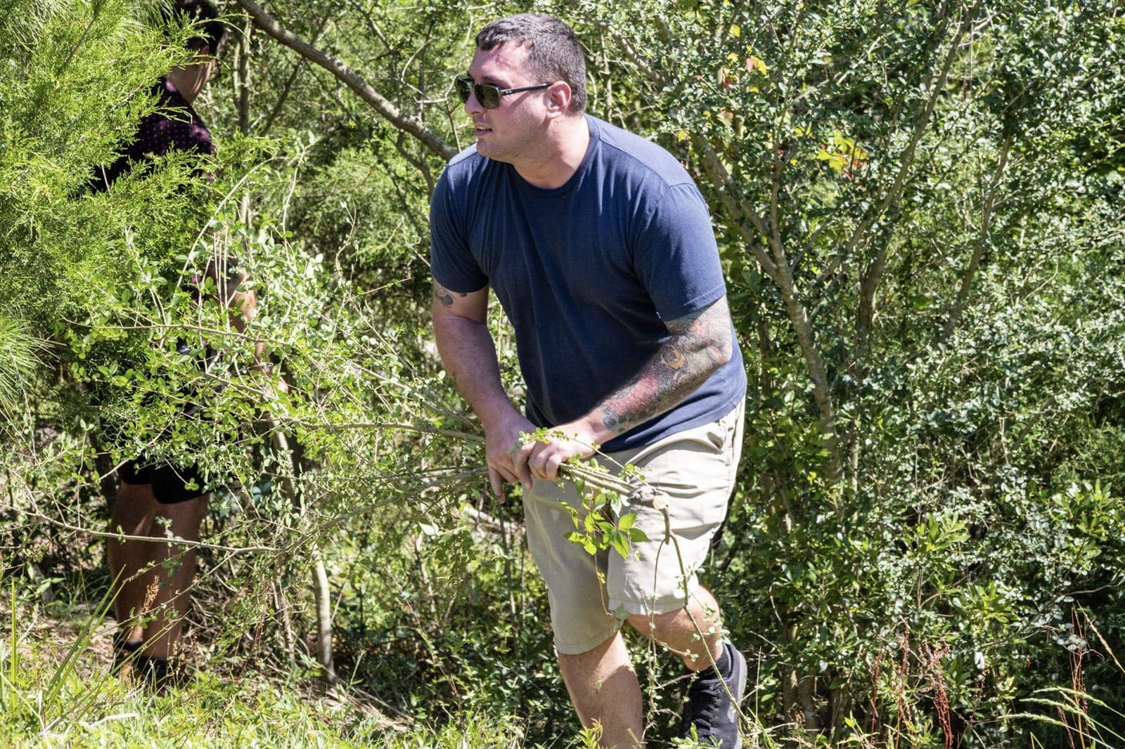 A volunteer clears brush at Majette on a spring work day.